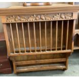 Pine wall hung kitchen plate and cup rack with carved acorn panel to top,