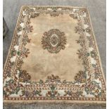 A large Indian beige and floral patterned 100% wool rug - 273 x 367cm