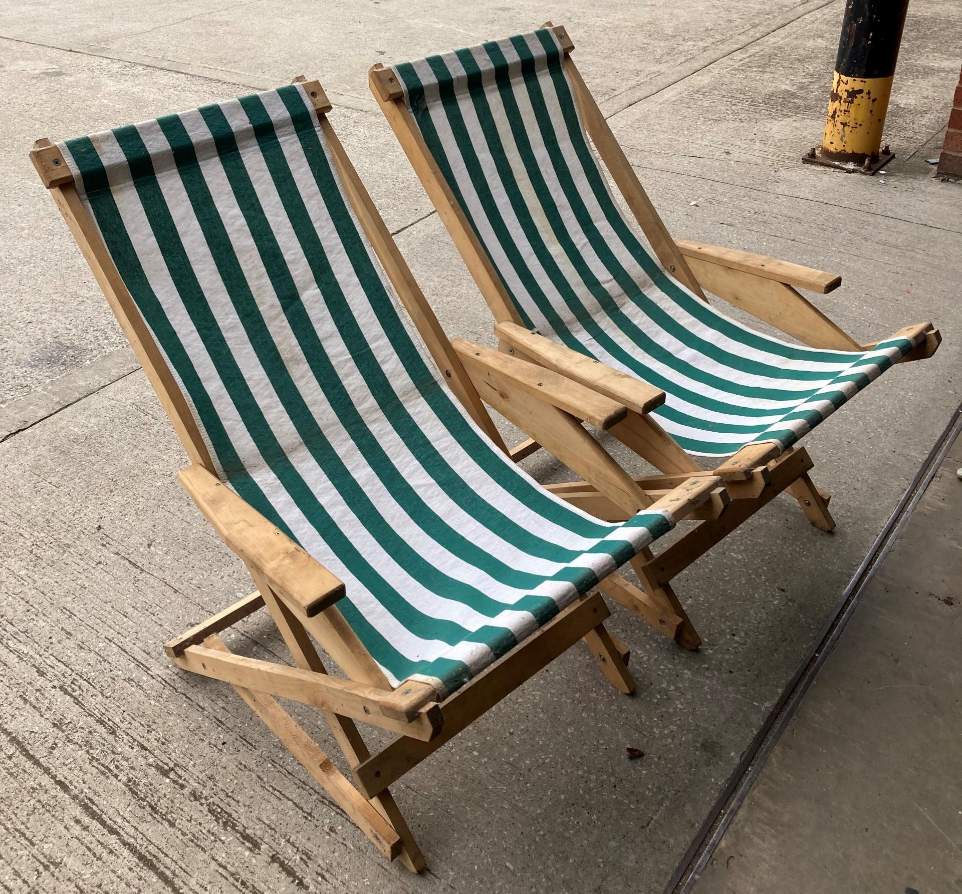 Pair of wooden deck armchairs with green and white striped material (saleroom location: MA4)