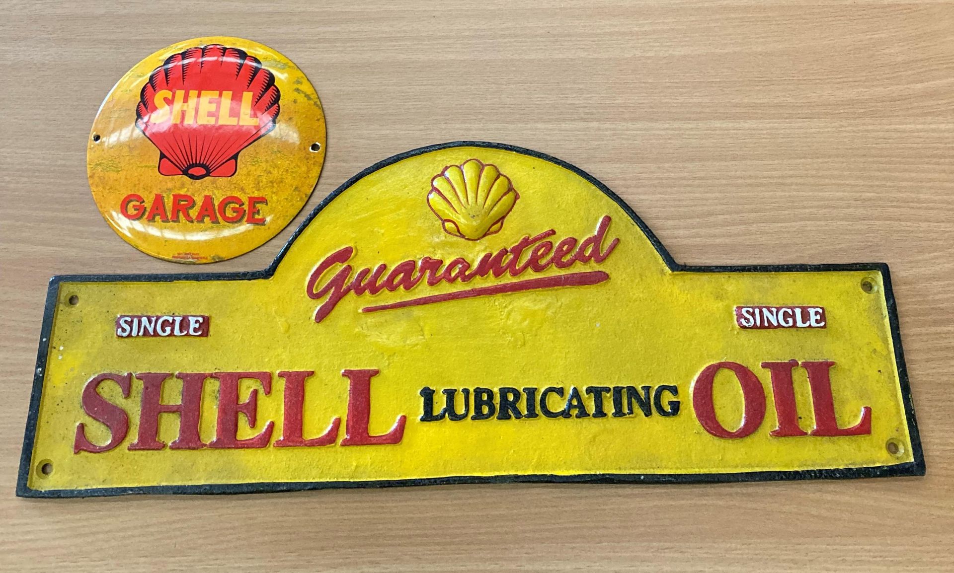 'Shell Lubricating Oil' cast iron name plate/sign and a circular 'Shell Garage' metal sign,