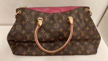 A brown patterned hand bag with pink lining and gold-tone hardware(sold as seen) (saleroom