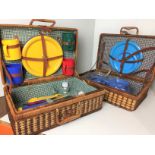 Two wicker picnic baskets 48 x 32 x 16cm high and 19cm high both partly fitted with plastic plates,