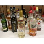 A bottle of Smirnoff Gold No 21 Cinnamon Flavoured Liqueur and twenty three part-full and