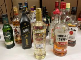 A bottle of Smirnoff Gold No 21 Cinnamon Flavoured Liqueur and twenty three part-full and