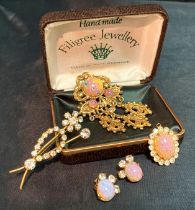 A collection of vintage/Kitsch jewellery including a rhinestone floral brooch,