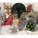 Box containing Christmas tree stand and Christmas tree decorations including tinsel, lights,