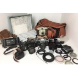 Grey plastic box containing photographic equipment including two Pentax Spotmatic cameras,