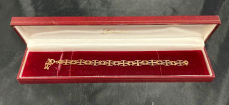 A 9ct [stamped: 375] gold Geneve bracelet (7" long, one broken link - boxed) approximate weight 4.