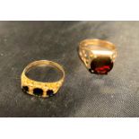 Two gold rings - one 9ct [stamped: 375 - size O] with a dark red stone in the centre and the other