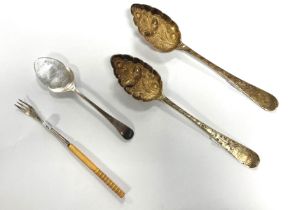 A selection of silverware including two matching serving spoons with acorn and foliate