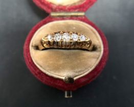 An 18ct gold ring (stamp faded) with five diamonds (tested) approximate weight 2.