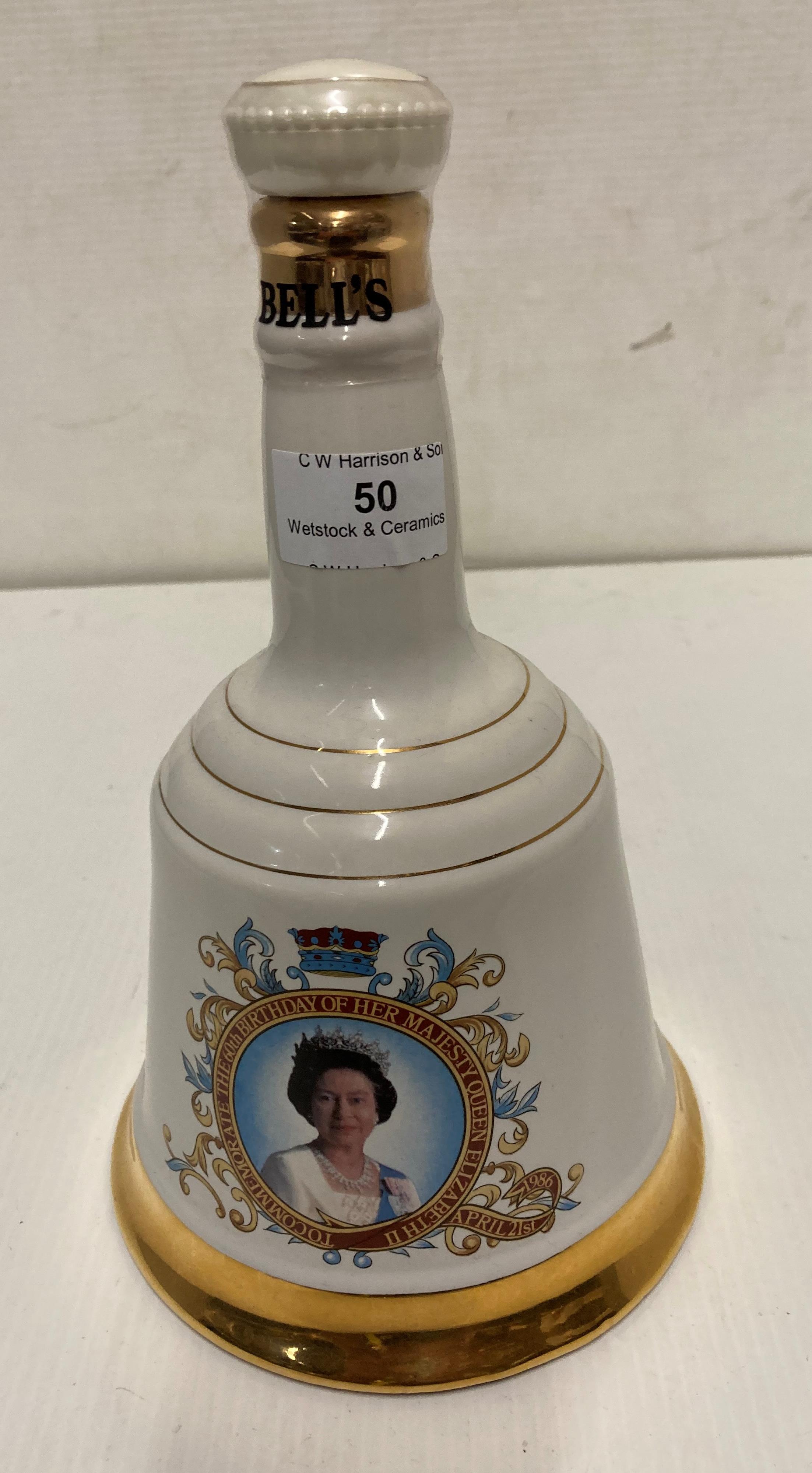 A Wade porcelain decorative decanter containing 75cl of Bell's Scotch whisky to commemorate Queen