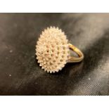 A 9ct [stamped: 375] gold cocktail ring with a large quantity of stones,