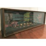 A glass fronted wooden case containing a display of reproduction golf clubs and balls,