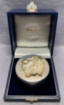 Silver [hallmarked] circular box with lions head lid in display case by RICHARD O A JARVIS.