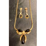 A 9ct [stamped: 375] gold necklace with clear and black stones (clear stones testing as diamond -