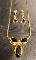A 9ct [stamped: 375] gold necklace with clear and black stones (clear stones testing as diamond -