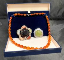 Three items - a boxed graduated lobster-clasp necklace (possibly copal amber),