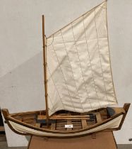 A model Balsa wood rowing boat together with single mast - length 63cm,