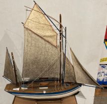 A model wooden yacht painted white and blue (masts dirty) total length 60cm,