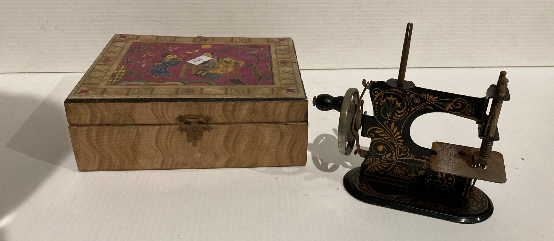 German Muller TSM/Miniature toy sewing machine in black and gold in a wooden box (saleroom