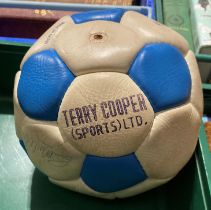 A Terry Cooper Sports white and blue football containing a number of signatures from some Leeds