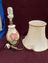 A Moorcroft Magnolia pattern with pink flowers to white back ground table lamp with cream shade