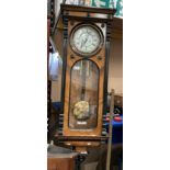 A walnut cased Vienna-style wall-clock complete with winding handle (total length approximately