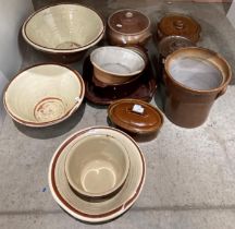 Twelve assorted stoneware items including pancheons, cooking pots,