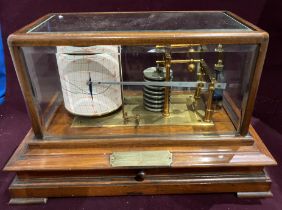 A barograph in a mahogany case with bevelled glass panels (36 x 25 x 24cm high) with brass