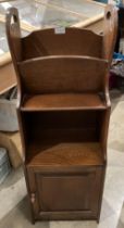 A small oak magazine rack/bookcase with single door 35 x 100cm high (saleroom location: S3T7)