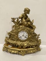 A gilt finish figural mantel clock surmounted by a young girl and mounted on plinth - 45cm high