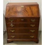 A mahogany reproduction bureau with drop-leaf over four-drawer base with fitted interior,