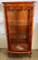 Bow fronted burr walnut finish single door china cabinet with etched glass door and two internal