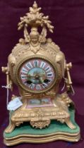 An ormolu mantel clock with coloured dial and panel and mounted on plinth - 34cm high,