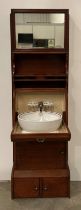 A Cunard Liners early 20th Century wash stand in mahogany with fall-front mirror over three-bowl