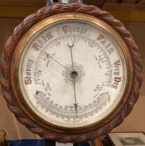 A circular wall barometer in oak case 27cm dia