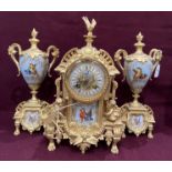 A gilt finish Continental clock garniture - the central clock decorated with birds and puttii and