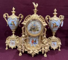 A gilt finish Continental clock garniture - the central clock decorated with birds and puttii and
