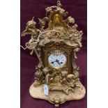 A brass mantel clock decorated with birds and puttii on brown onyx base - 35cm high (saleroom