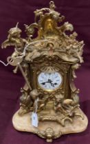 A brass mantel clock decorated with birds and puttii on brown onyx base - 35cm high (saleroom