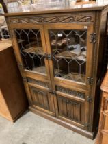 An oak Old Charm wall unit with leaded glazed doors over two door base,