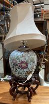 Large blue ground oriental floral patterned table lamp on hardwood oriental stand complete shade,