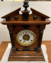 A Fattorini & Sons Bradford oak mantel clock with pendulum and key with patent automatic alarm,