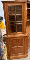 An Albert Oldroyd of Cawthorne hand-made oak corner cabinet with wood lined upper glazed door over