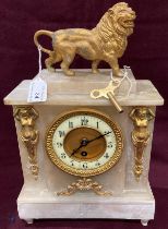 An onyx and gilt metal mantel clock with lion to top - 35cm high,