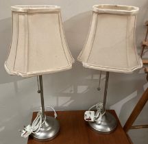 Pair of IKEA B9819 pull cord table lamps in a brushed satin chrome finish both with shades