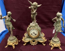 A green marble, metal and gilt finish clock garniture, the clock surmounted by a puttii 38cm high,
