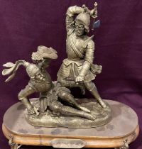 A gilt finish metal figure group of two knights in mortal combat mounted on a wood plinth - plinth