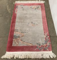 Pink and multicoloured Chinese woolen rug size 93cm x 152cm (saleroom location: MA7)